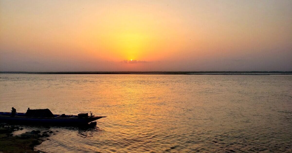 A breathtaking dance of colors unfolds as the sun bids farewell to the sky and river, casting a spellbinding glow that whispers of tranquility and dreams. Witness the magic of a sunset-kissed horizon, where nature paints a masterpiece of serene serenity.